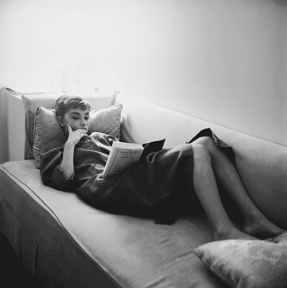 Artwork - Audrey Hepburn Supine Reading on Couch, 1953