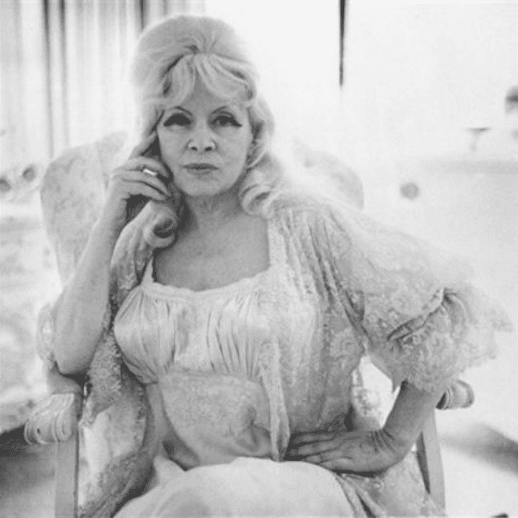 Mae West in a Chair at Home