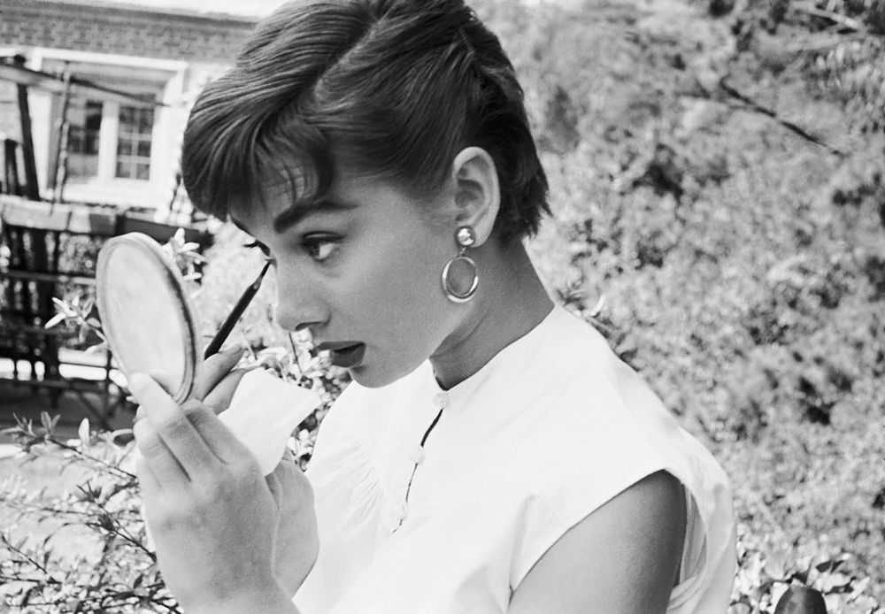 Mark Shaw, ‘Audrey Hepburn Putting on Makeup in Mirror 1953’, 1953, Print, Pigment print on Hahnemϋhle photo rag paper, null,