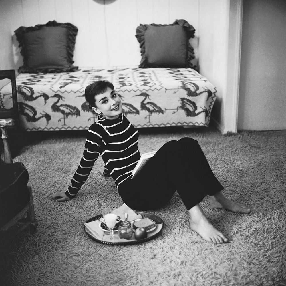 Mark Shaw, ‘Audrey Hepburn in Striped Sweater Lounges, Arms Back, Smiling, 1953’, 1953, Print, Pigment print on Hahnemϋhle photo rag paper, null,