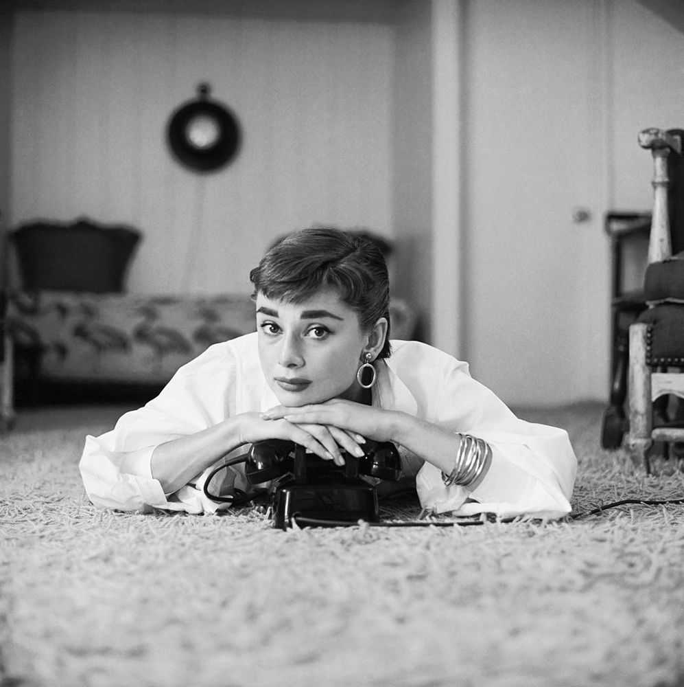 Mark Shaw, ‘Audrey Hepburn in White Blouse With Phone, Laying, Chin Resting, 1953’, 1953, Print, Pigment print on Hahnemϋhle photo rag paper, null,