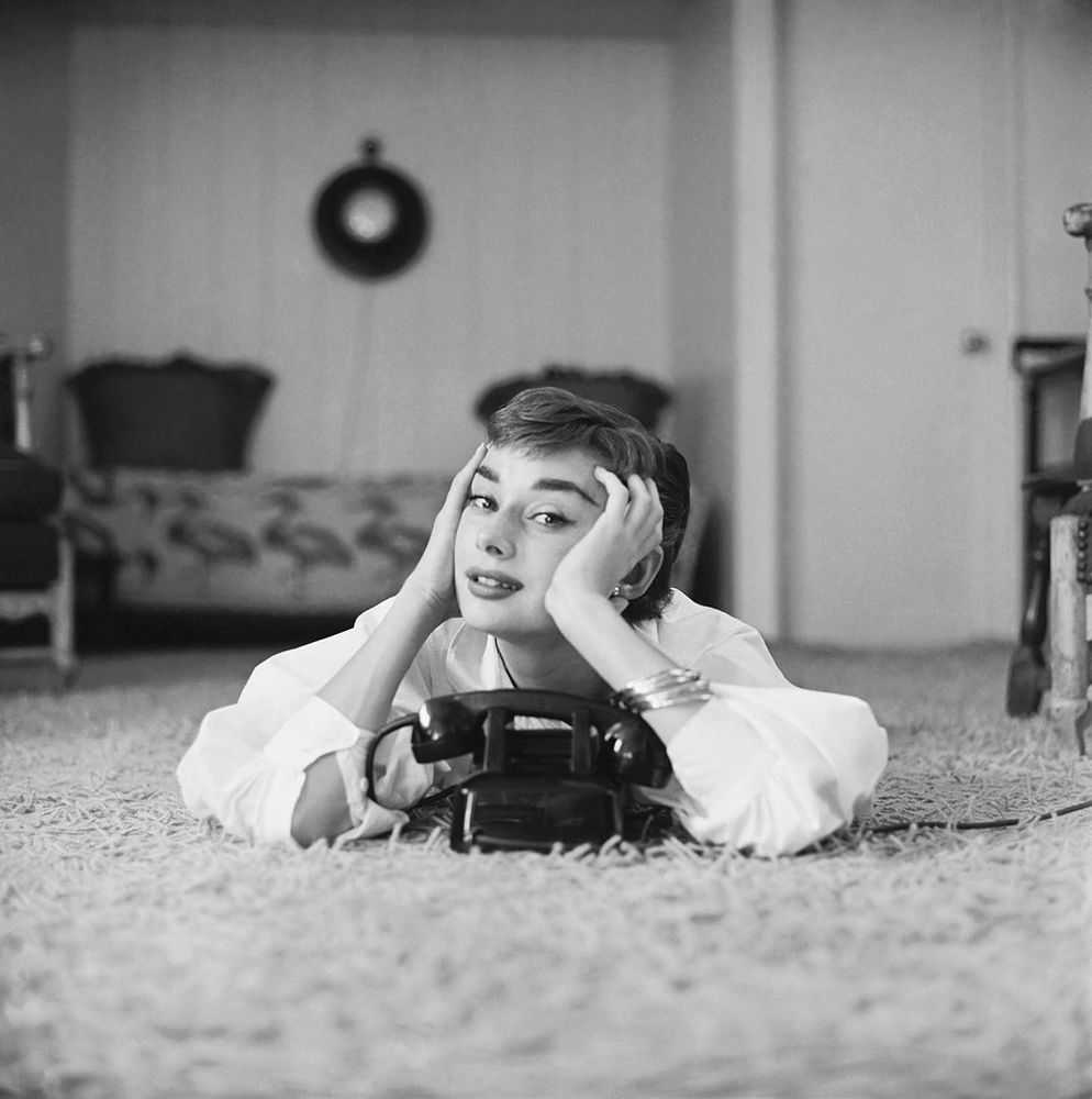 Mark Shaw, ‘Audrey Hepburn in White Blouse With Phone, Laying, Hands on Face, 1953’, 1953, Print, Pigment print on Hahnemϋhle photo rag paper, null,