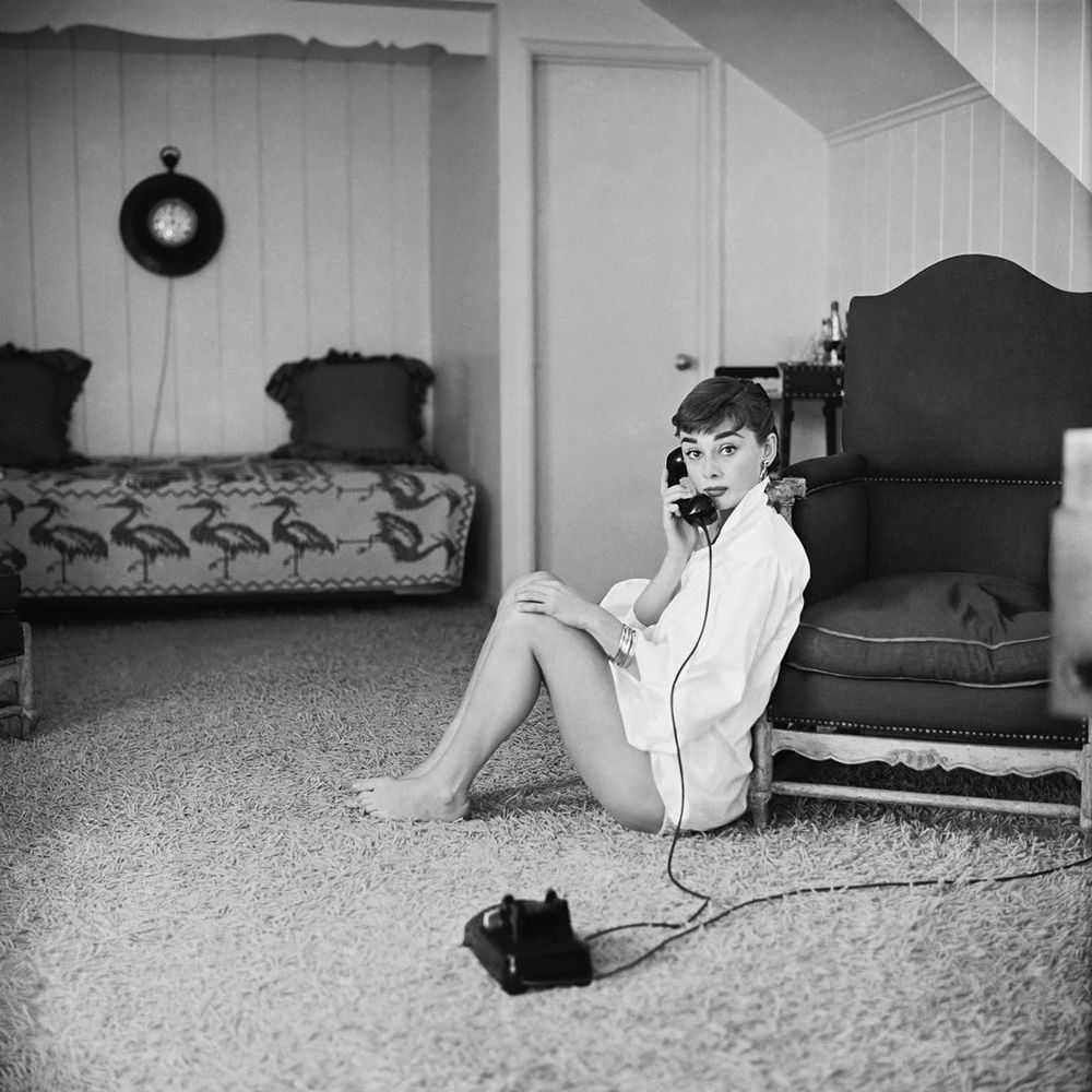 Mark Shaw, ‘Audrey Hepburn in White Blouse With Phone, Leaning Against Chair, 1953’, 1953, Print, Pigment print on Hahnemϋhle photo rag paper, null,